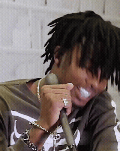 Man With Dreadlocks And Ring Holding Microphone GIF