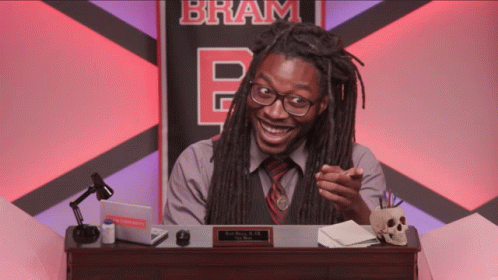 Man With Dreadlocks At Desk GIF
