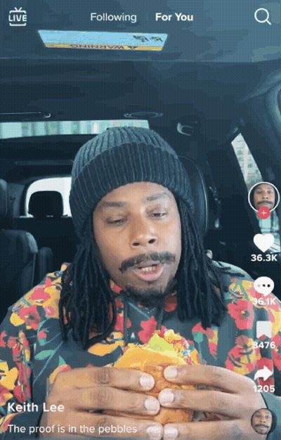 Man With Dreadlocks Eating Hamburger GIF