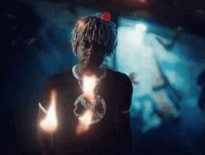 Man With Dreadlocks Holding Candle GIF