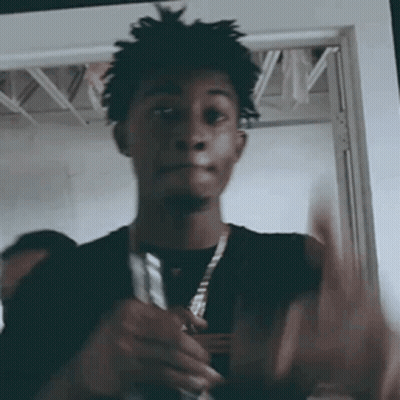 Man With Dreadlocks Holding Knife In Front Of Door GIF