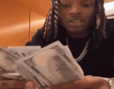 Man With Dreadlocks Holding Stack Of Money GIF