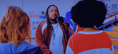 Man With Dreadlocks In Front Of Vikings Wall GIF