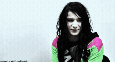 Man With Dreadlocks In Green And Pink Jacket GIF