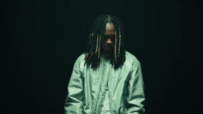 Man With Dreadlocks In Green Jacket And White Shirt GIF