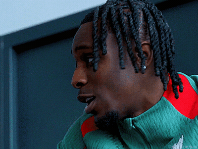 Man With Dreadlocks In Green Shirt GIF