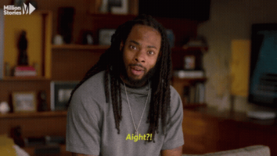 Man With Dreadlocks In Grey Shirt Saying Aight GIF