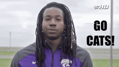 Man With Dreadlocks In Purple Jacket Says Go Cats GIF