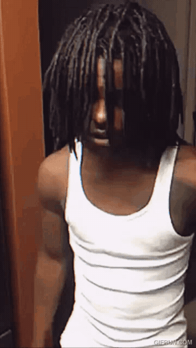 Man With Dreadlocks in White Tank Top