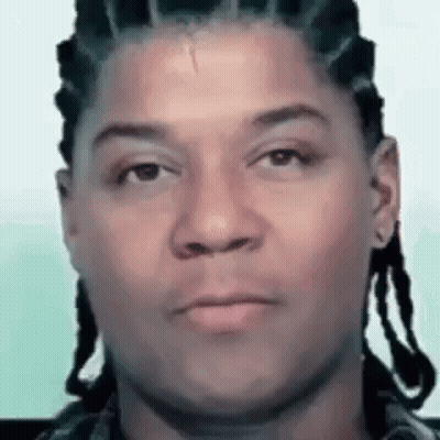 Man With Dreadlocks Looking At Camera GIF