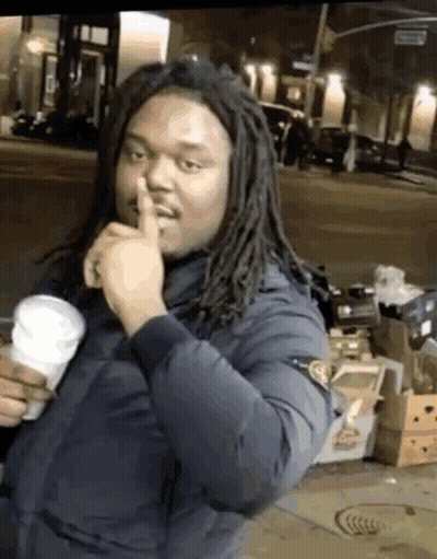 Man With Dreadlocks Making Shhh Gesture GIF