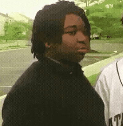 Man With Dreadlocks Next To Man In Baseball Jersey GIF