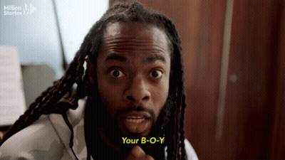 Man With Dreadlocks Saying Your B-O-Y In Front Of Million Stories Logo GIF