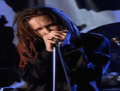 Man With Dreadlocks Singing Into Microphone GIF