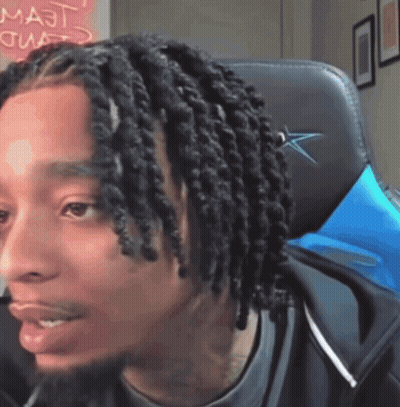Man With Dreadlocks Sitting In Chair With Majt On Wall GIF
