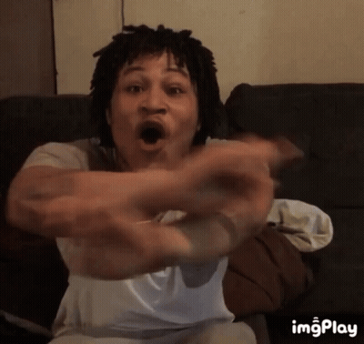 Man With Dreadlocks Sitting On Couch Arms Outstretched GIF