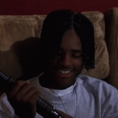 Man With Dreadlocks Sitting On Couch Looking GIF