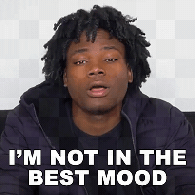 Man With Dreadlocks Sitting On Couch Says I'm Not In The Best Mood GIF