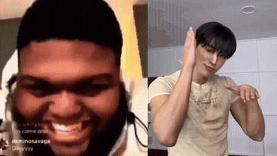 Man With Dreadlocks Smiling Next To Man In Tan Shirt GIF