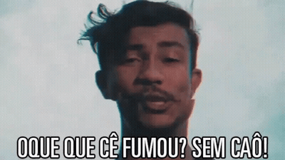 Man With Dreadlocks Smoking Cigarette In Dark Room GIF
