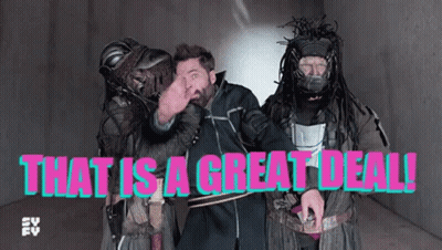Man With Dreadlocks Standing Beside Two Costumed Men Saying That Is A Great Deal GIF