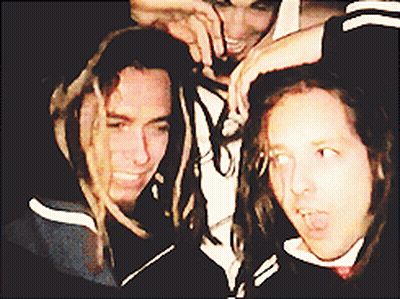 Man With Dreadlocks Standing Next To Two Men GIF