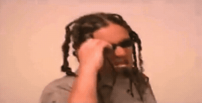 Man With Dreadlocks Talking On Cell Phone Wearing Sunglasses GIF