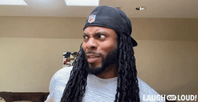 Man With Dreadlocks Wearing NFL Hat GIF