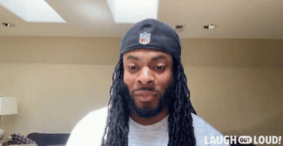 Man With Dreadlocks Wearing NFL Hat Laughing Out Loud GIF