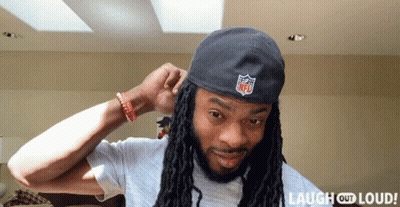 Man With Dreadlocks Wearing NFL Logo Hat GIF