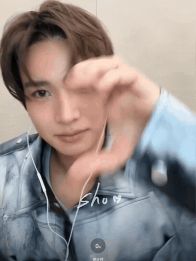 Man With Earbuds Making Heart With Hand GIF