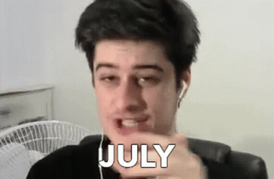 Man With Earbuds Pointing At Camera Word July GIF