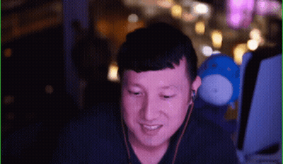 Man With Earbuds Smiling In Front Of Blue Stuffed Animal GIF