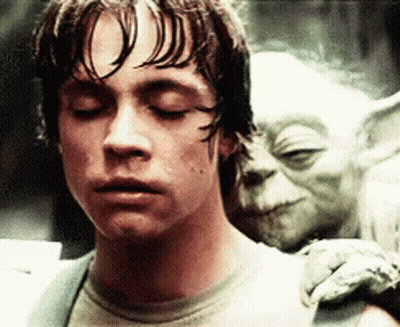 Man With Eyes Closed And Yoda Statue GIF