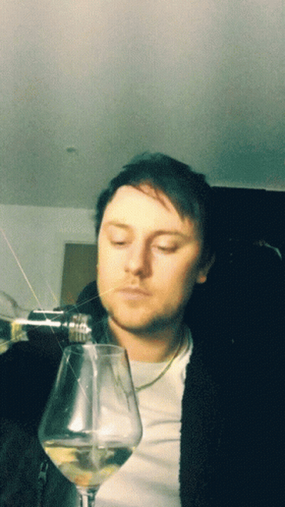 Man With Eyes Closed Holding Wine Glass GIF
