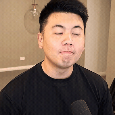 Man With Eyes Closed In Black Shirt And Microphone GIF