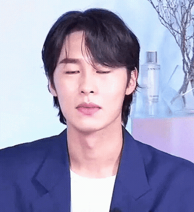 Man With Eyes Closed In Blue Jacket And White Shirt GIF