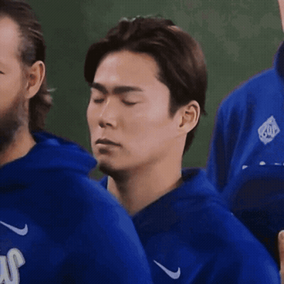 Man With Eyes Closed In Blue Nike Jacket GIF