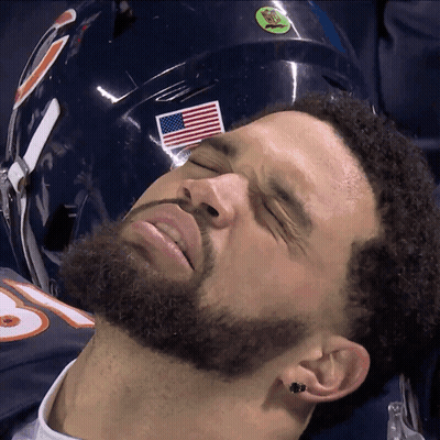 Man With Eyes Closed Lying Next To American Flag Helmet GIF