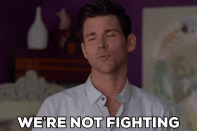 Man With Eyes Closed Saying We're Not Fighting GIF