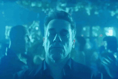 Man With Eyes Closed Surrounded By Blue Lights GIF