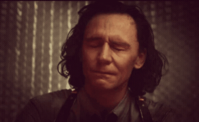 Man With Eyes Closed Wearing Apron And Tie GIF