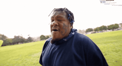 Man With Face Tattoo In Grassy Field GIF