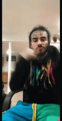 Man With Face Tattoo In Hoodie Saying X GIF