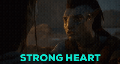 Man With Face Tattoo Looks At Another Saying Strong Heart GIF