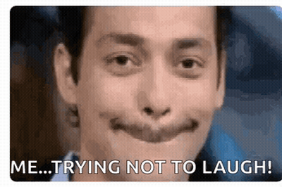 Man With Fake Smile Saying Me Trying Not To Laugh GIF