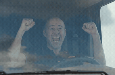 Man With Fist In Air Driving Truck GIF