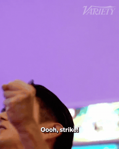 Man With Fist In Air Saying Oooh Strike In Front Of Variety Logo GIF
