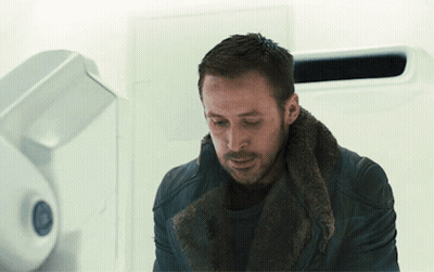 Man With Fur Collar Looking Down GIF