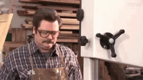 Man With Glasses And Apron At Band Saw GIF